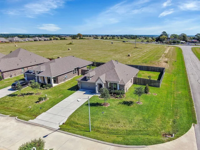 an aerial view of residential houses with outdoor space and swimming pool