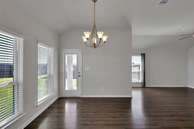 a view of a room with wooden floor and window