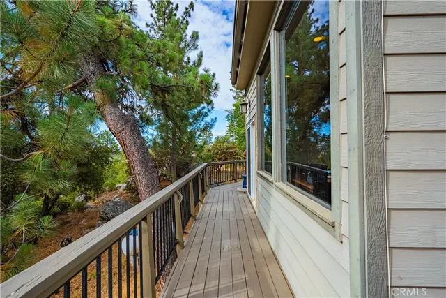 a dining room with furniture and a floor to ceiling window