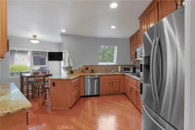 a bathroom with a granite countertop toilet sink and mirror