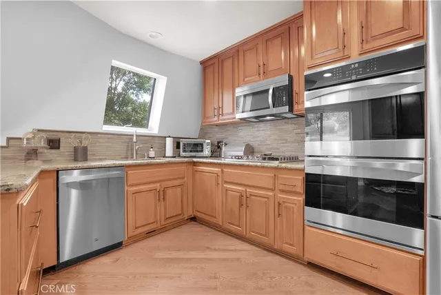 a bathroom with a granite countertop sink a mirror and a bathtub