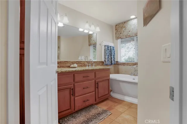 a bathroom with a tub shower vanity and a sink