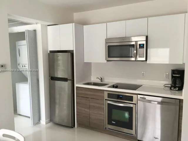 a kitchen with stainless steel appliances a refrigerator stove and microwave
