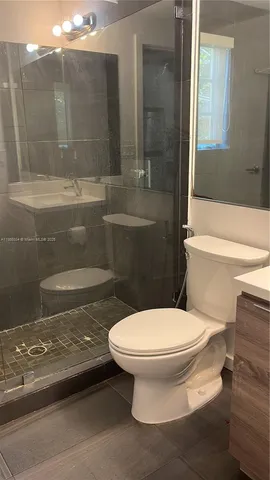 a bathroom with a toilet and a shower