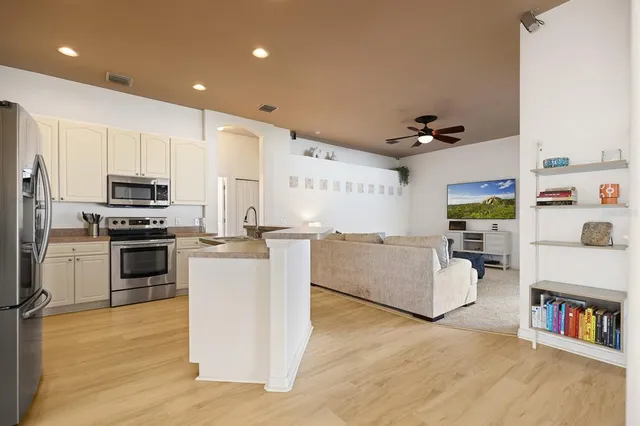 a kitchen with furniture and a wooden floor