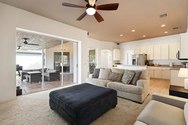 a living room with furniture and kitchen view