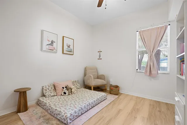 a bedroom with a bed and wooden floor