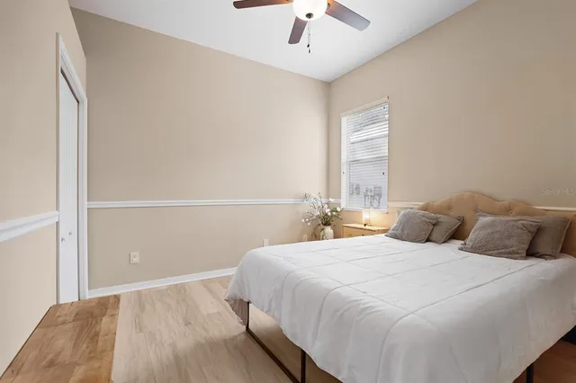 a bedroom with a large bed and a large window