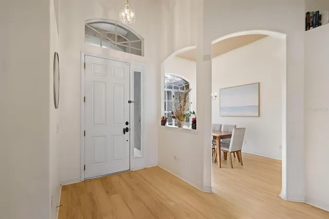 a view of a livingroom with wooden floor and furniture