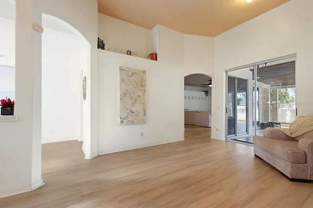 a view of a livingroom with wooden floor and furniture