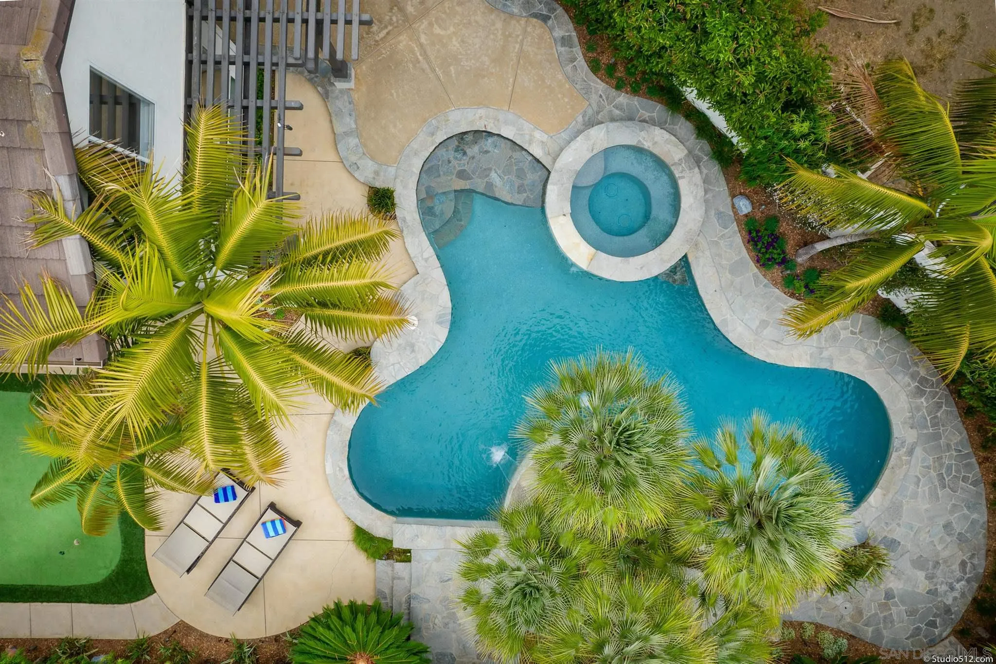 an aerial view of a swimming pool patio and outdoor seating