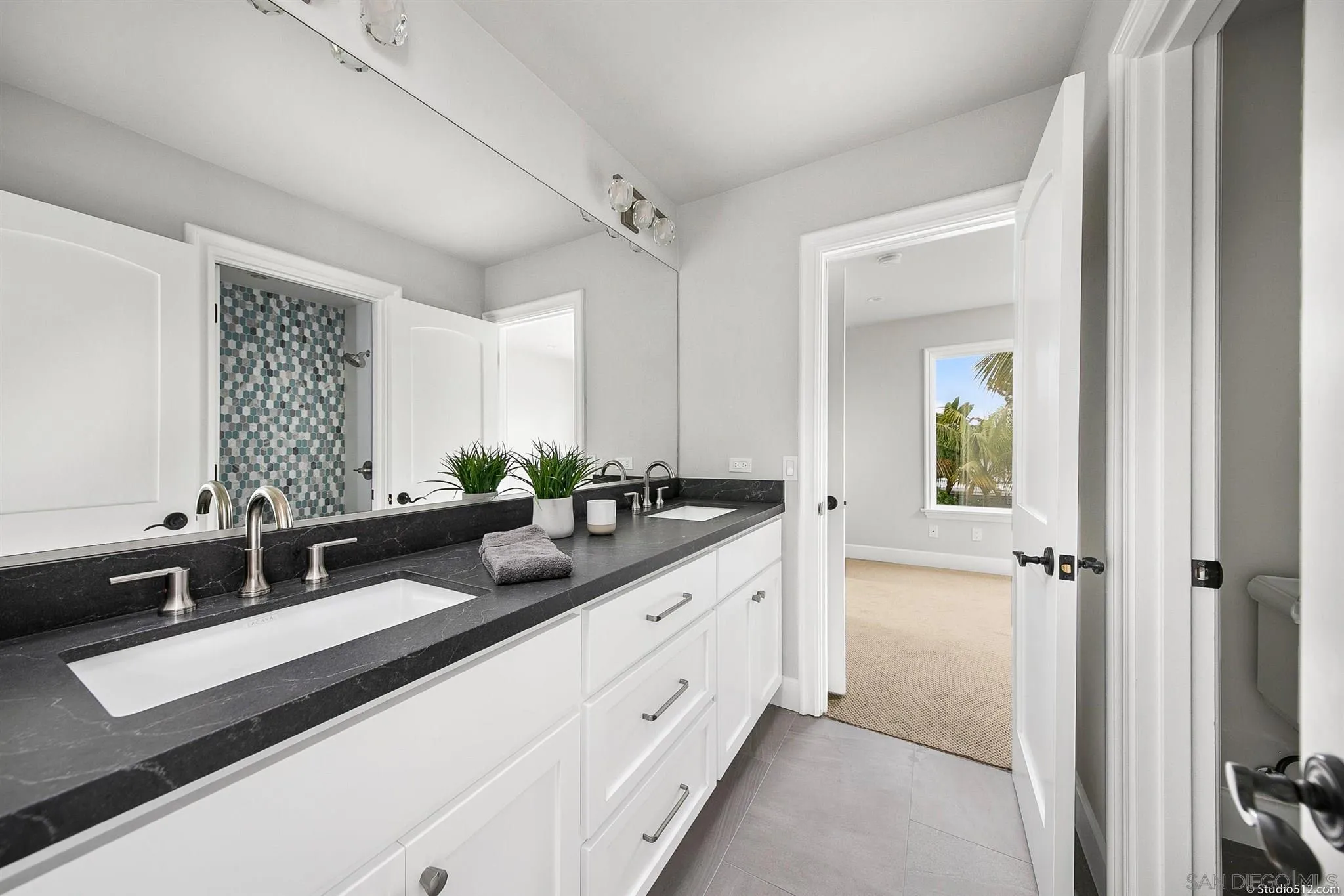 220 Jacob Lane Encinitas, CA 92024 - Photo 25 of 40 a bathroom with a double vanity sink and mirror