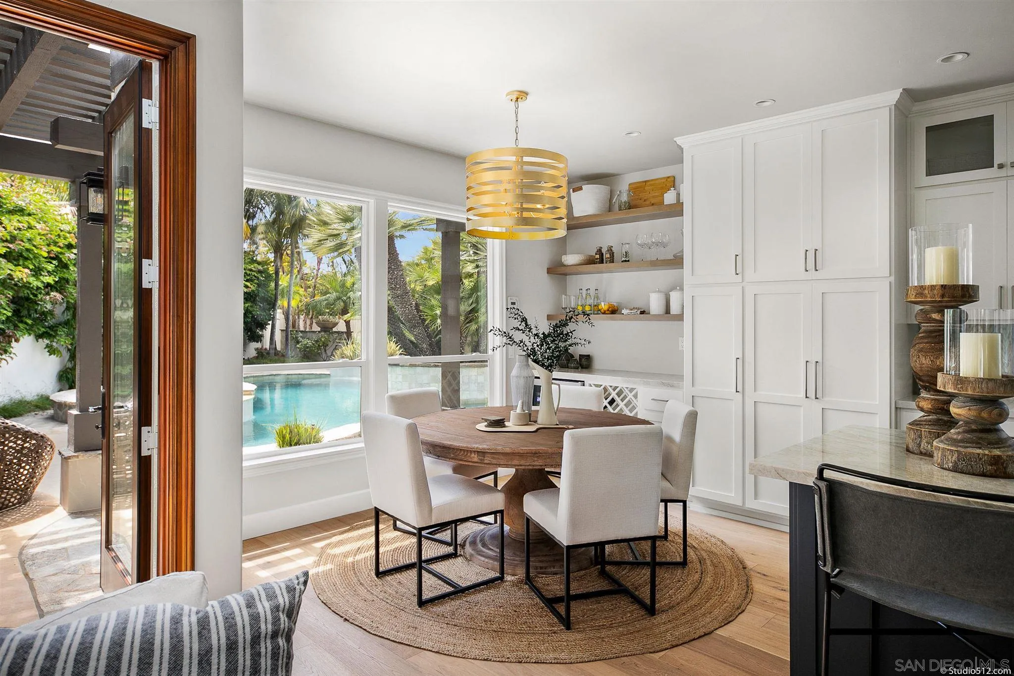 220 Jacob Lane Encinitas, CA 92024 - Photo 5 of 40 a dining room with furniture a chandelier and wooden floor