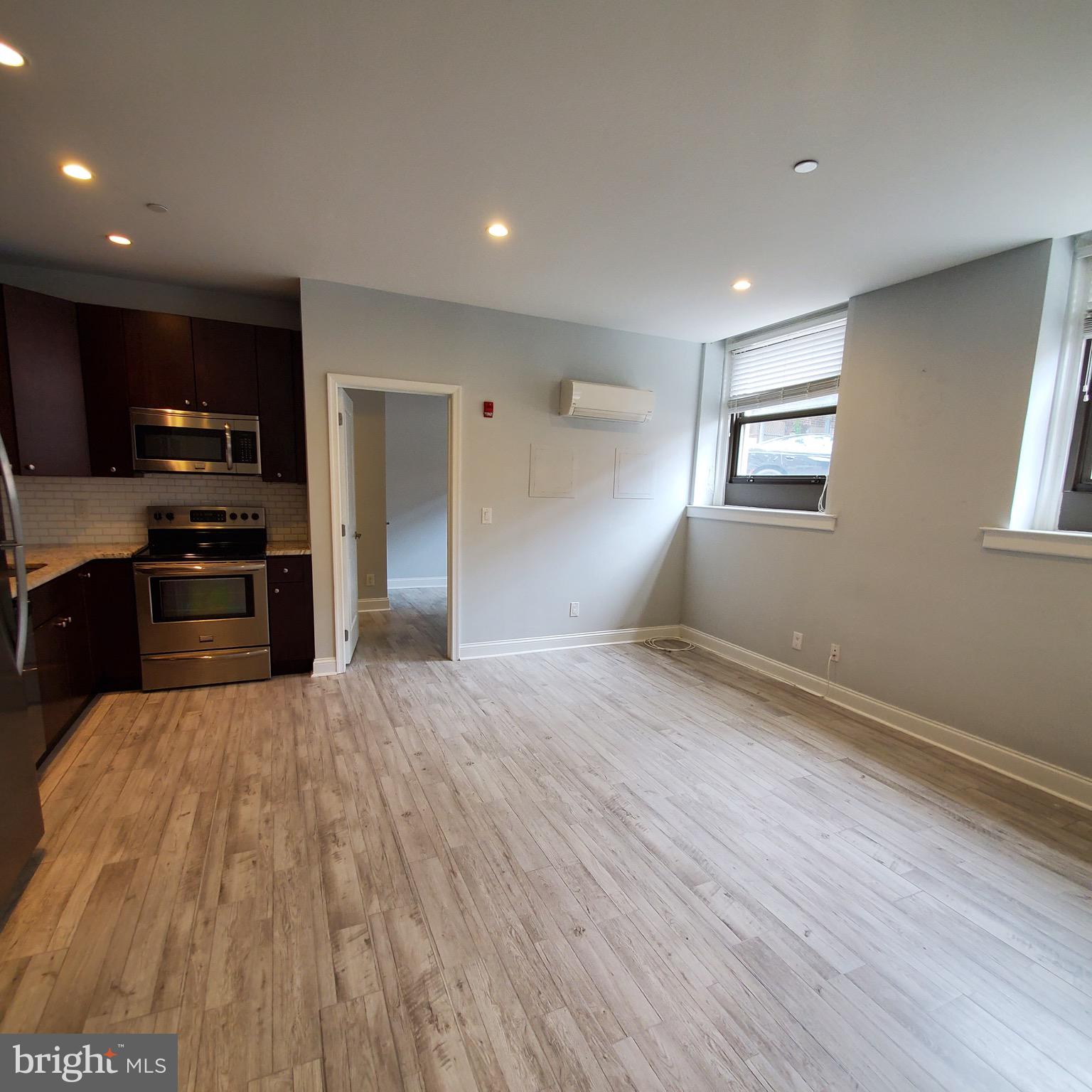 a kitchen with stainless steel appliances a refrigerator and a stove top oven