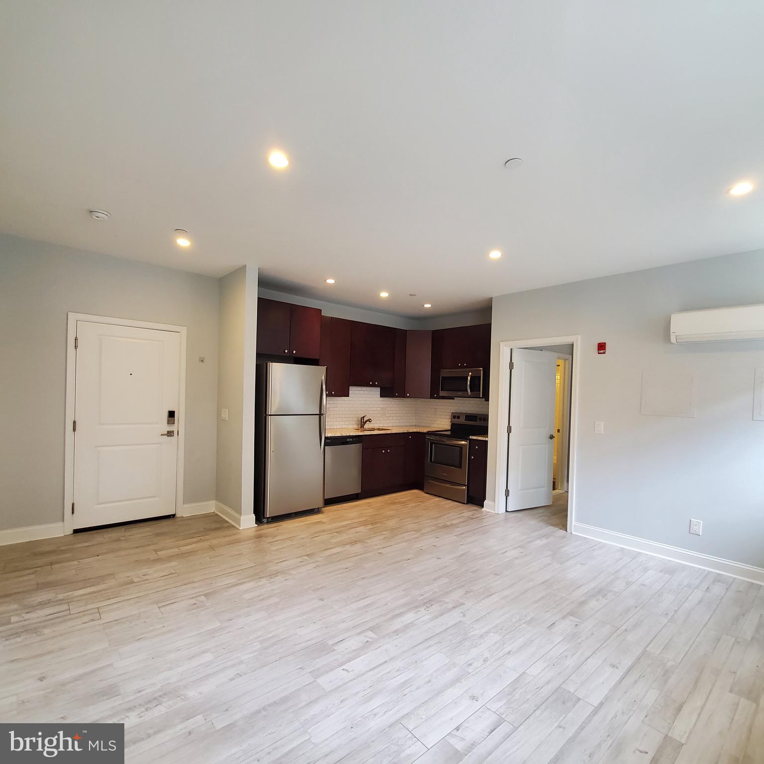 421-429 Monroe Street, Unit 102 Philadelphia, PA 19147 - Photo 2 of 10 a view of a kitchen with a sink and a refrigerator