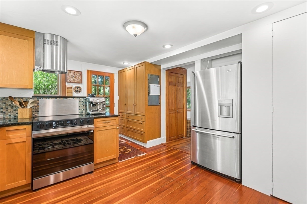 55 Pleasant Street Lexington, MA 02421 - Photo 16 of 42 a kitchen with stainless steel appliances a stove and a refrigerator