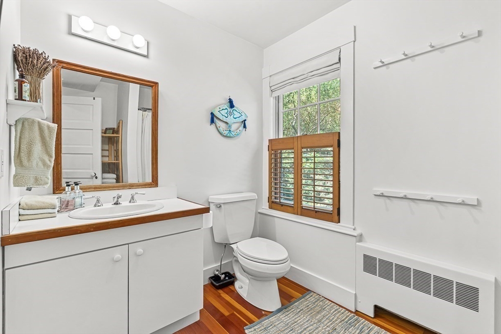 55 Pleasant Street Lexington, MA 02421 - Photo 23 of 42 a bathroom with a sink a toilet and a window