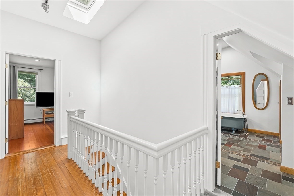 55 Pleasant Street Lexington, MA 02421 - Photo 24 of 42 a view of a hallway with wooden floor and windows