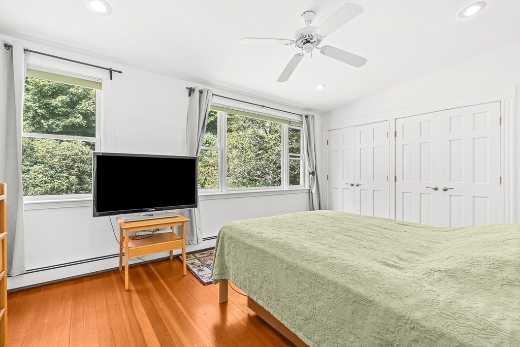 55 Pleasant Street Lexington, MA 02421 - Photo 28 of 42 a bedroom with a bed and a flat screen tv