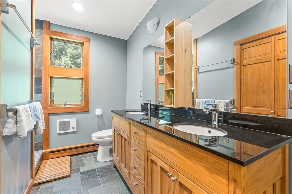 55 Pleasant Street Lexington, MA 02421 - Photo 31 of 42 a bathroom with a granite countertop sink mirror vanity and a bathtub