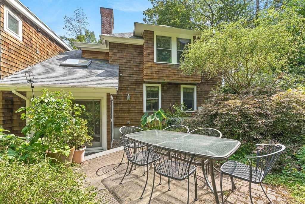 55 Pleasant Street Lexington, MA 02421 - Photo 40 of 42 a backyard of a house with table and chairs
