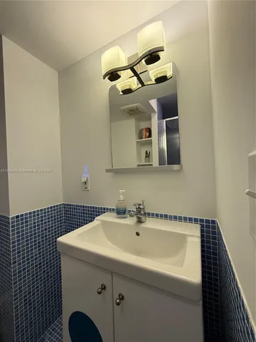 a bathroom with a sink and mirror