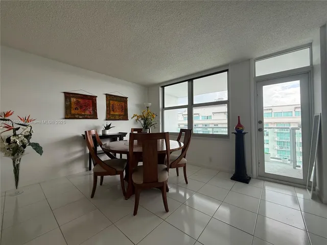 a view of a dining room with furniture and window