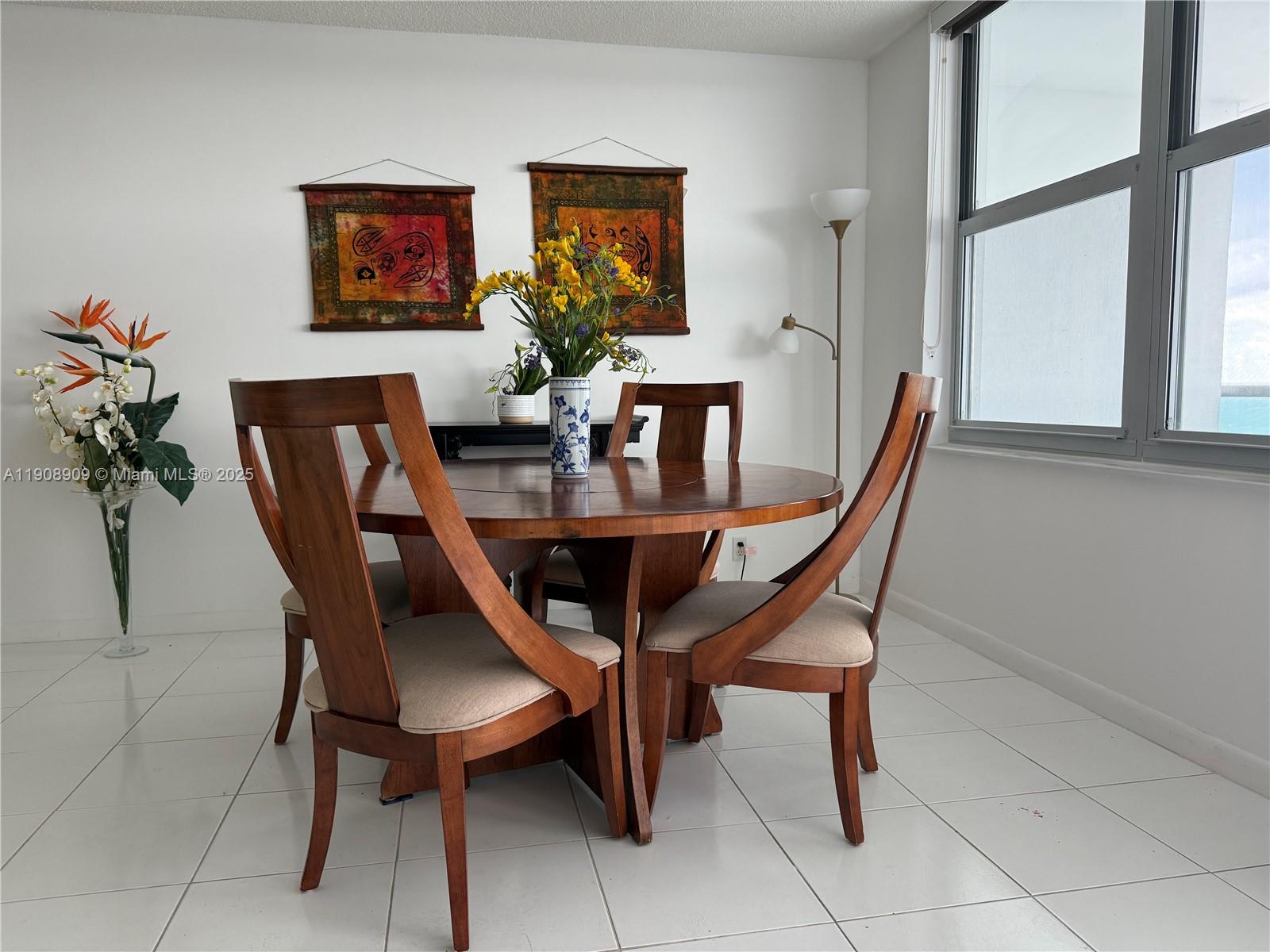9511 Collins Avenue, Unit 1208 Surfside, FL 33154 - Photo 10 of 37 a dining room with furniture and window