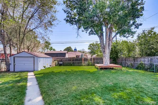 3880 Quay Street Wheat Ridge, CO 80033 - Photo 12 of 32 a view of a backyard with a garden and trees