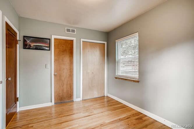 3880 Quay Street Wheat Ridge, CO 80033 - Photo 17 of 32 a view of an empty room with wooden floor and a window