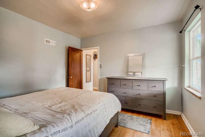 3880 Quay Street Wheat Ridge, CO 80033 - Photo 19 of 32 a bedroom with a bed and a dresser
