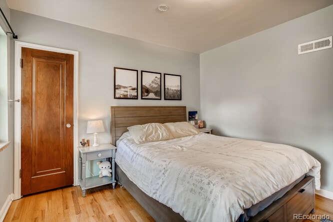 3880 Quay Street Wheat Ridge, CO 80033 - Photo 20 of 32 a bedroom with a bed and large window