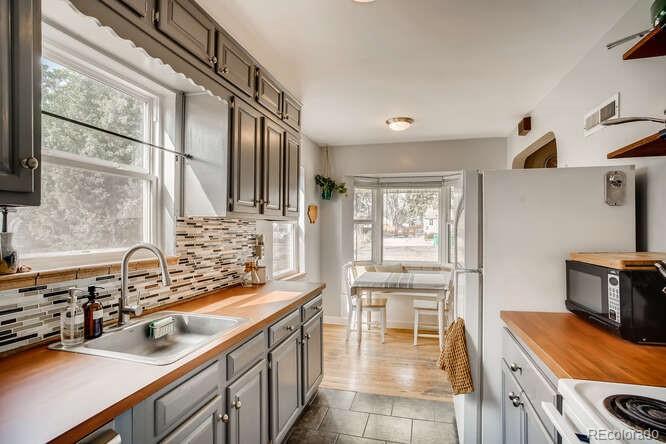 3880 Quay Street Wheat Ridge, CO 80033 - Photo 5 of 32 a kitchen with a sink and a refrigerator