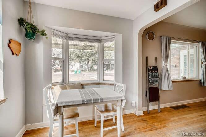 3880 Quay Street Wheat Ridge, CO 80033 - Photo 6 of 32 a view of a dining room with furniture window and wooden floor