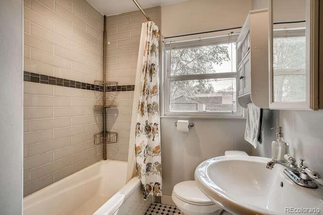 3880 Quay Street Wheat Ridge, CO 80033 - Photo 9 of 32 a bathroom with a sink toilet and shower