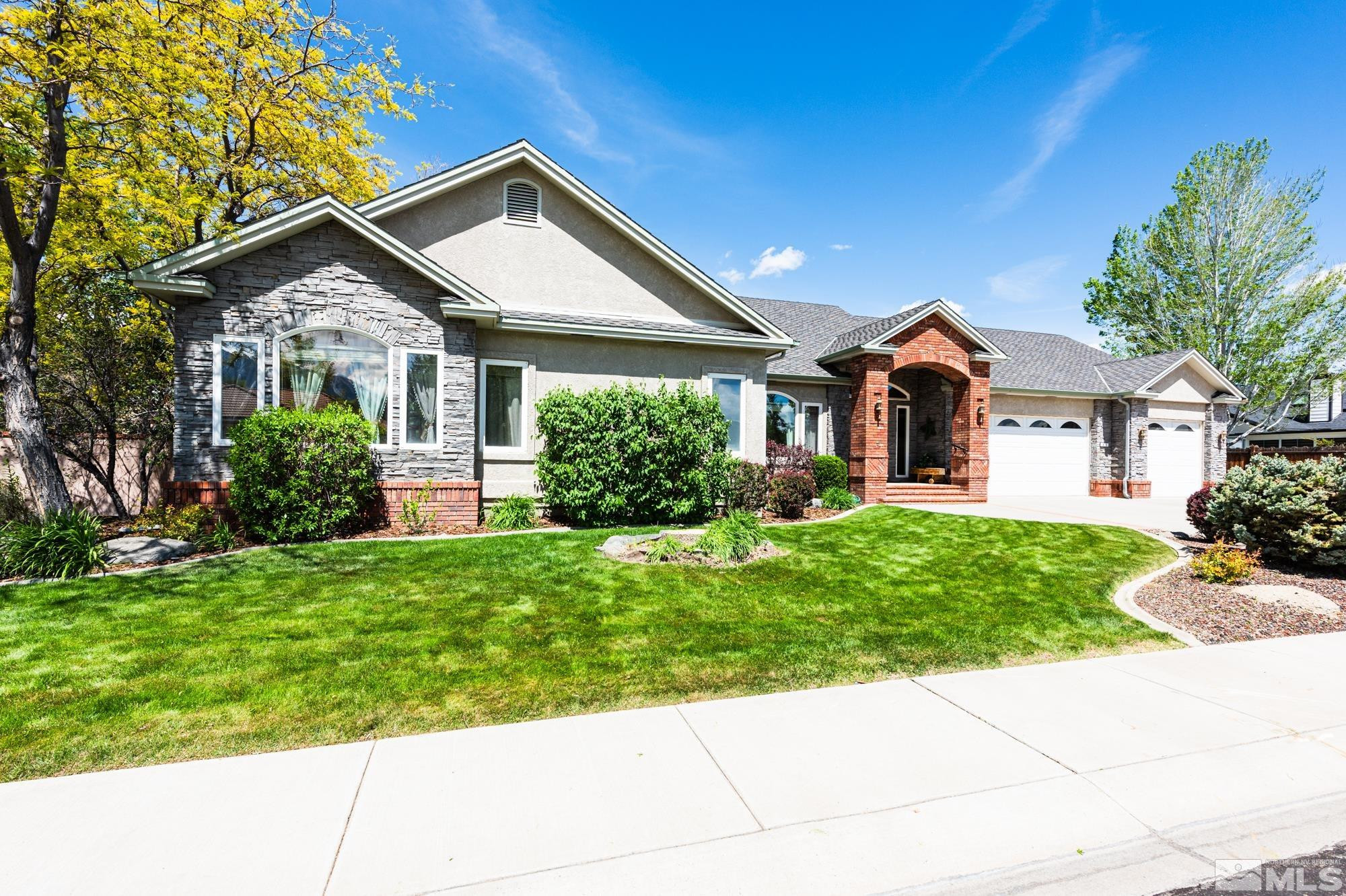 971 Fieldgate Way Gardnerville, NV 89460 - Photo 1 of 57 a front view of a house with a yard and potted plants
