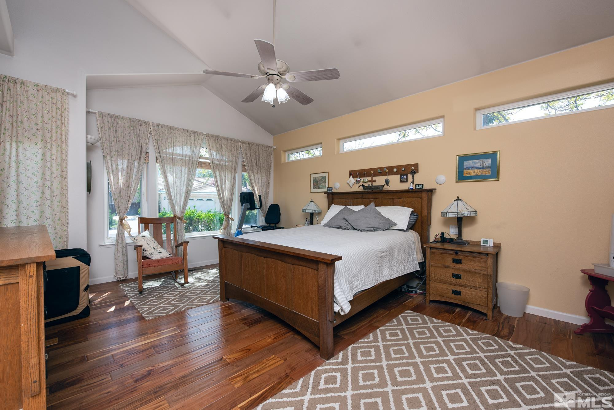 971 Fieldgate Way Gardnerville, NV 89460 - Photo 15 of 57 a bedroom with a large bed and a chandelier