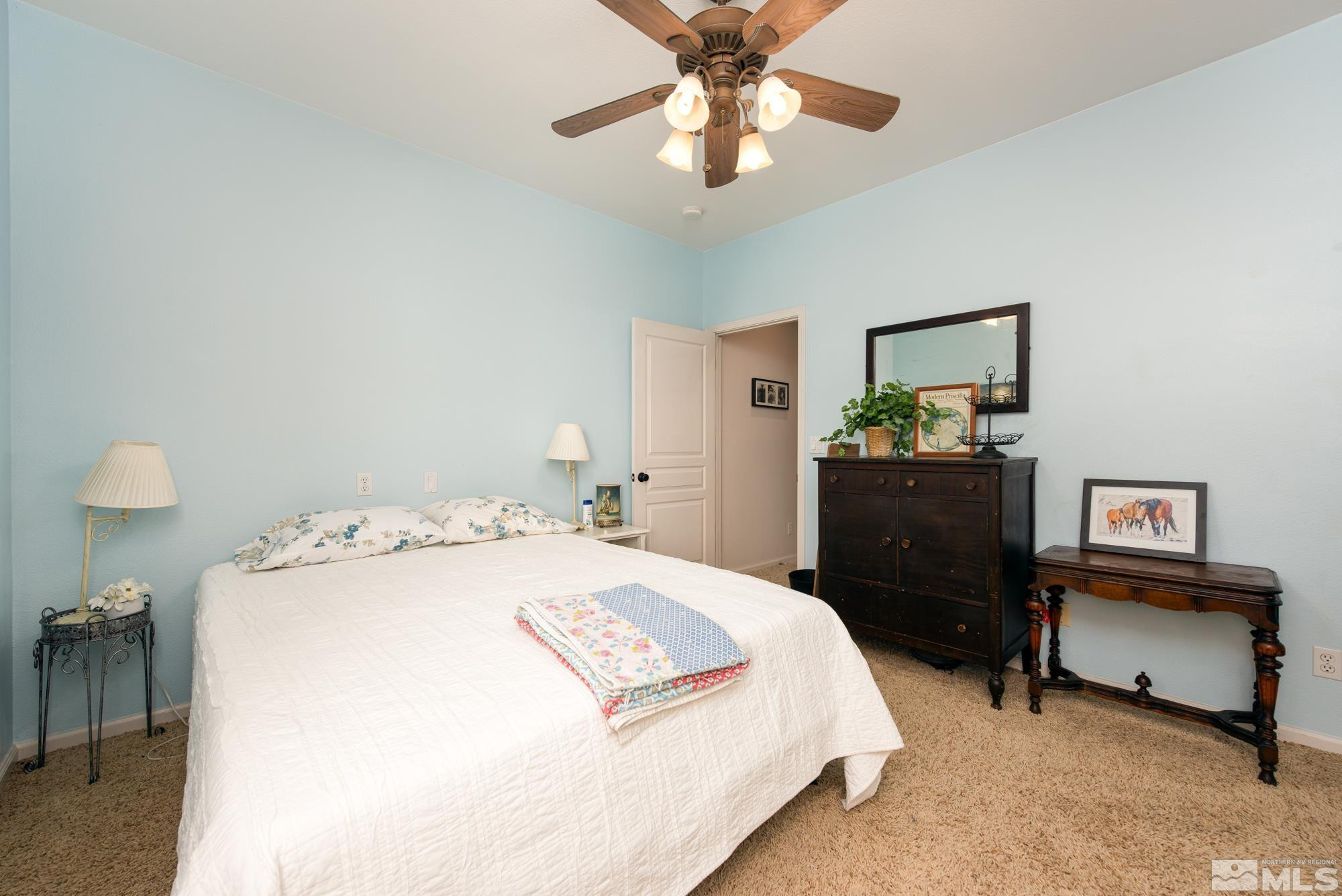 971 Fieldgate Way Gardnerville, NV 89460 - Photo 21 of 57 a bedroom with a bed and a chandelier