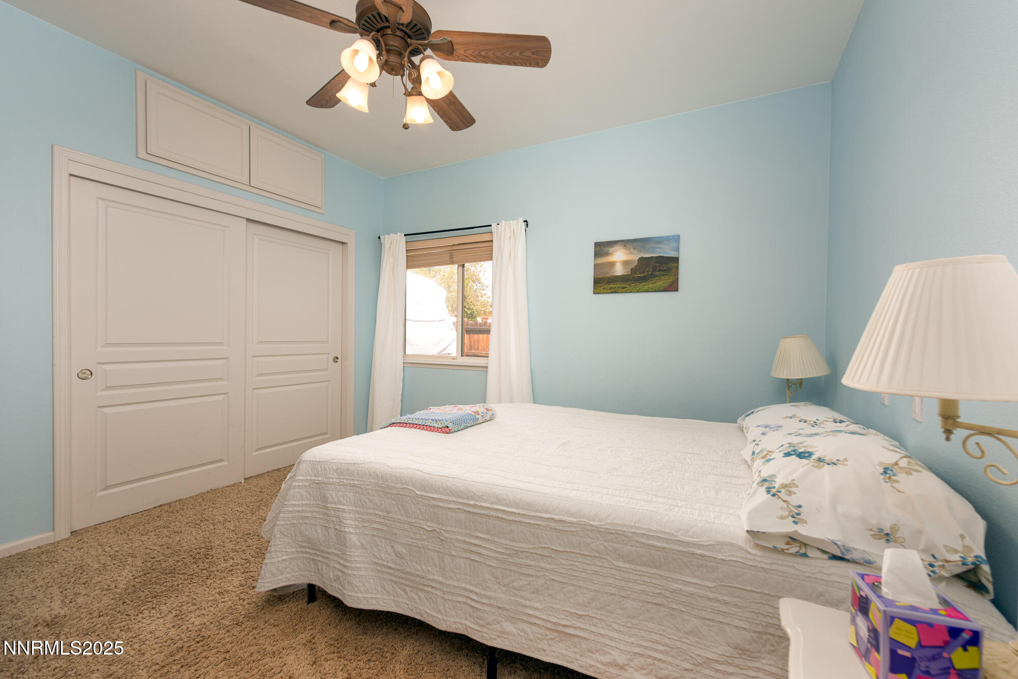 971 Fieldgate Way Gardnerville, NV 89460 - Photo 23 of 57 a bedroom with a bed and a chandelier