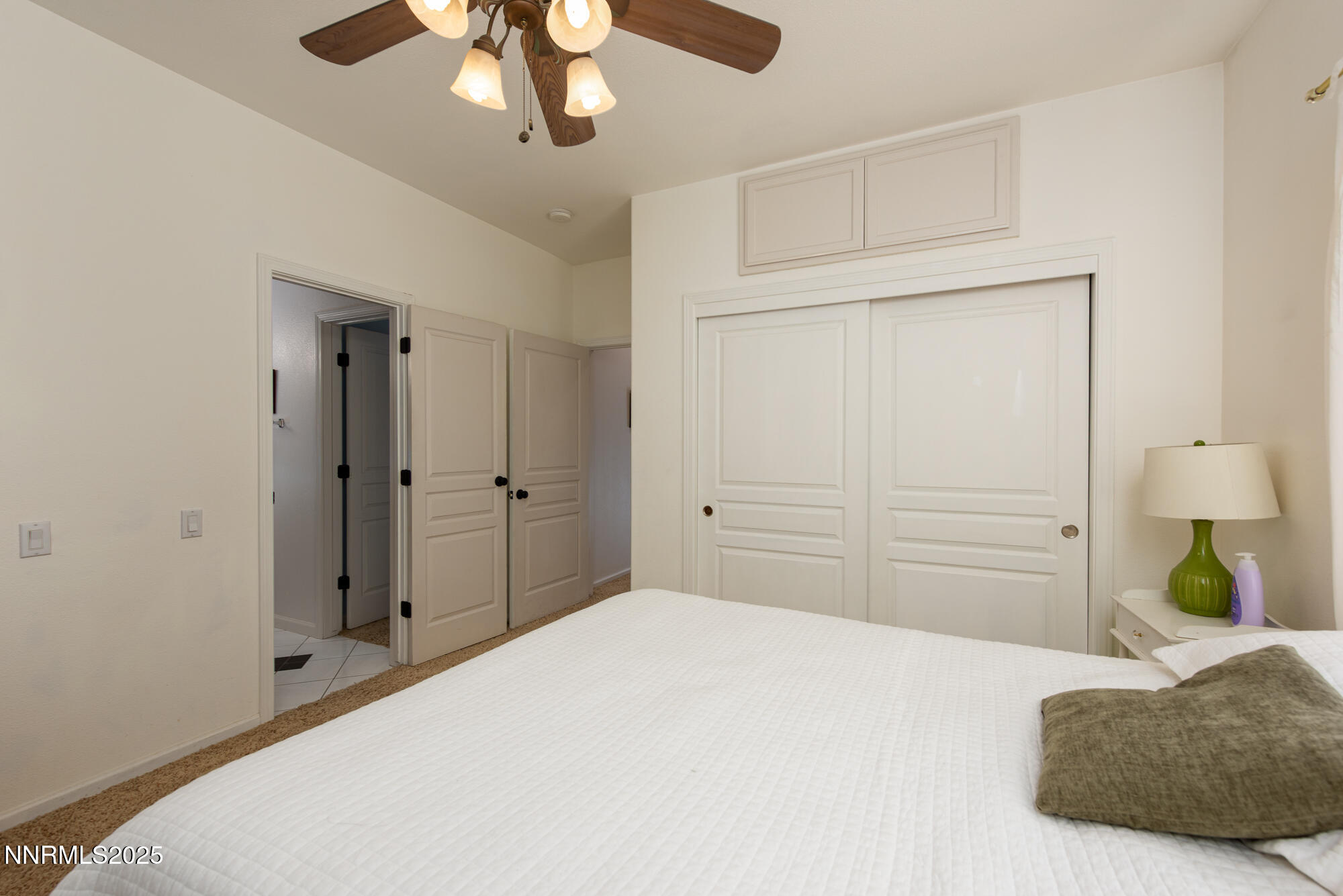 971 Fieldgate Way Gardnerville, NV 89460 - Photo 25 of 57 a bedroom with a bed and a chandelier