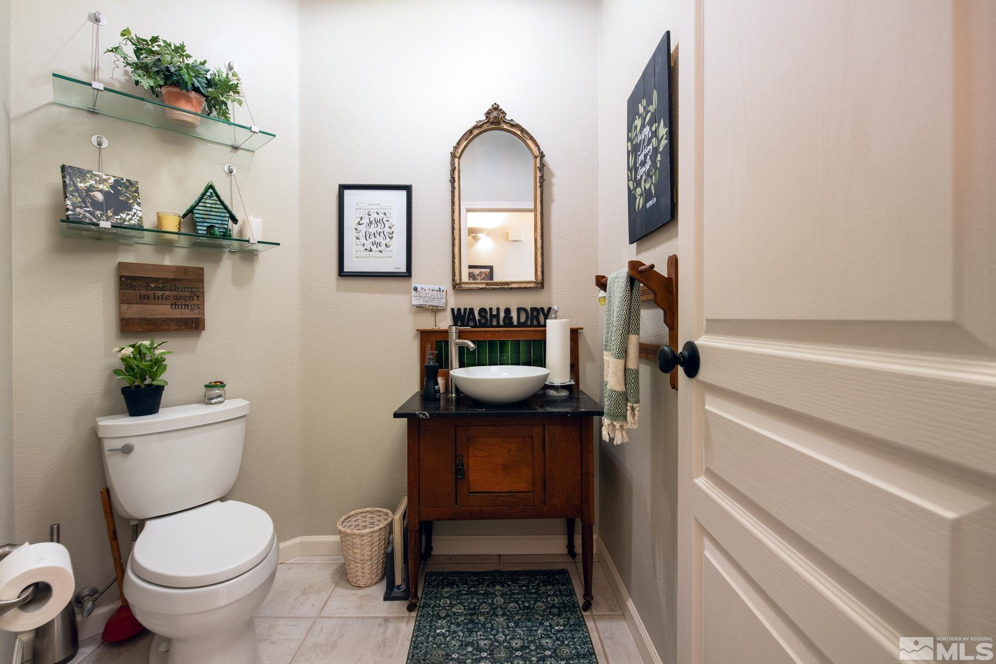 971 Fieldgate Way Gardnerville, NV 89460 - Photo 26 of 57 a bathroom with a toilet a sink and mirror
