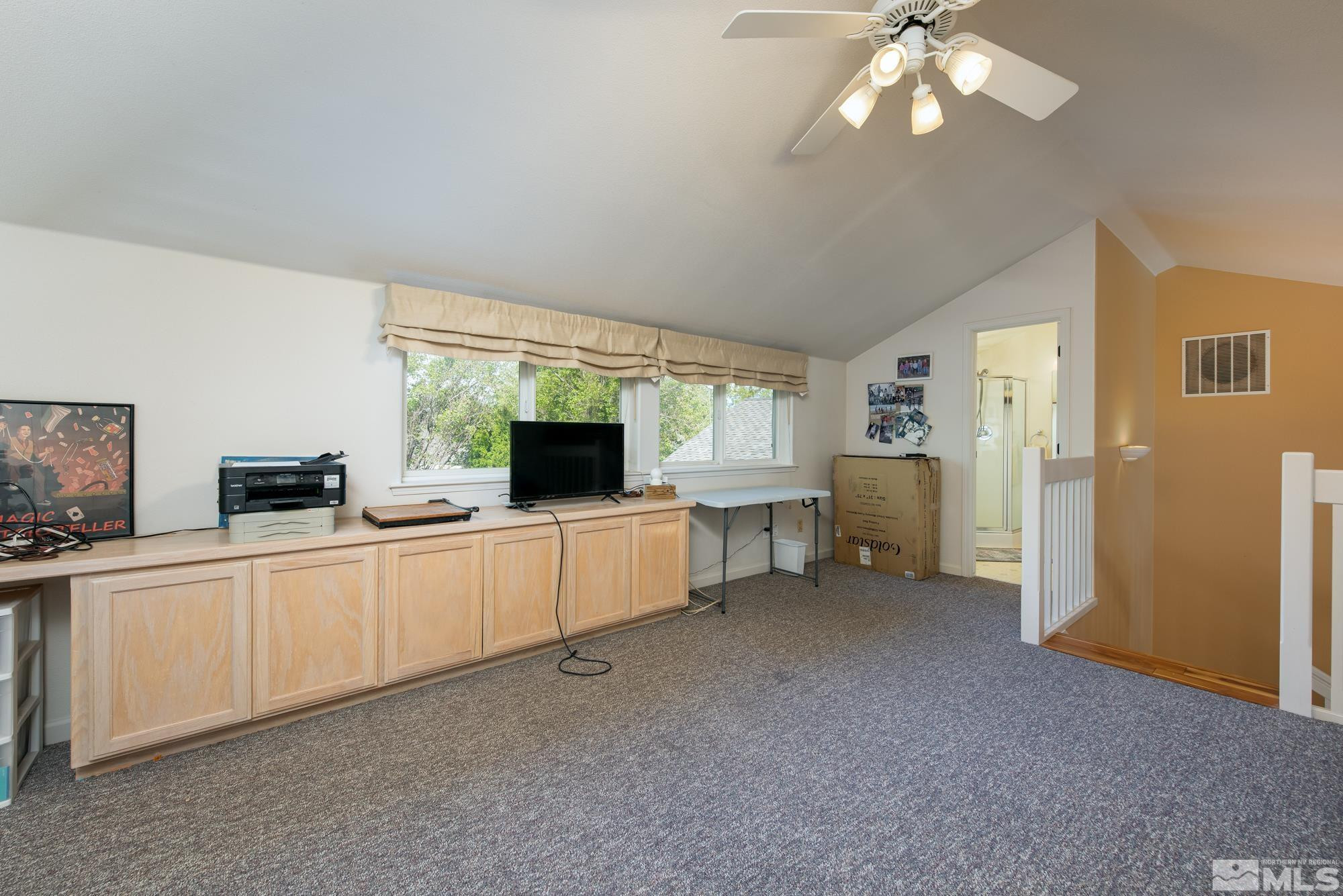 971 Fieldgate Way Gardnerville, NV 89460 - Photo 28 of 57 a large white kitchen with cabinets a sink a window and a couch
