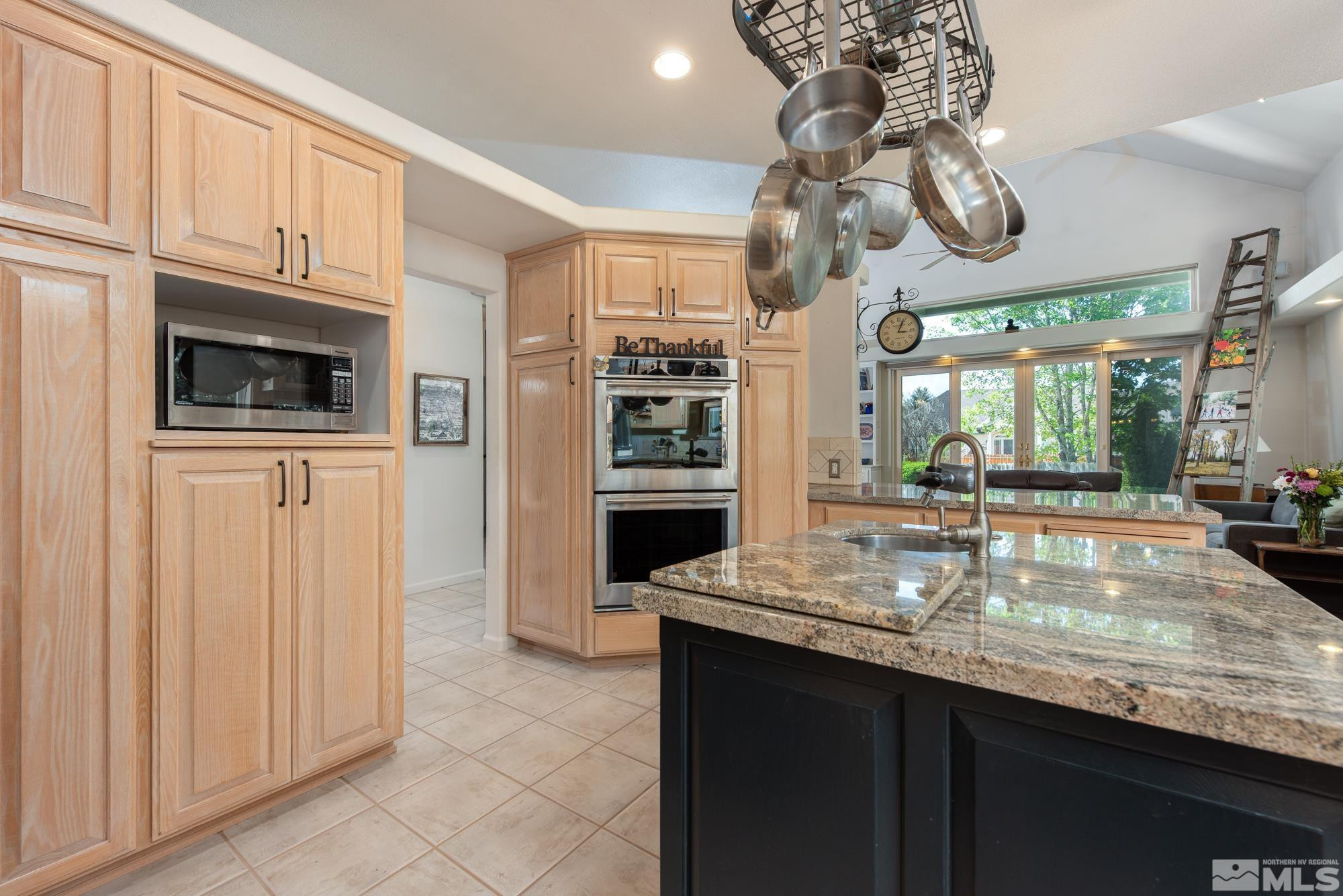 971 Fieldgate Way Gardnerville, NV 89460 - Photo 6 of 57 a kitchen with kitchen island granite countertop a refrigerator a stove a sink and dishwasher with wooden floor