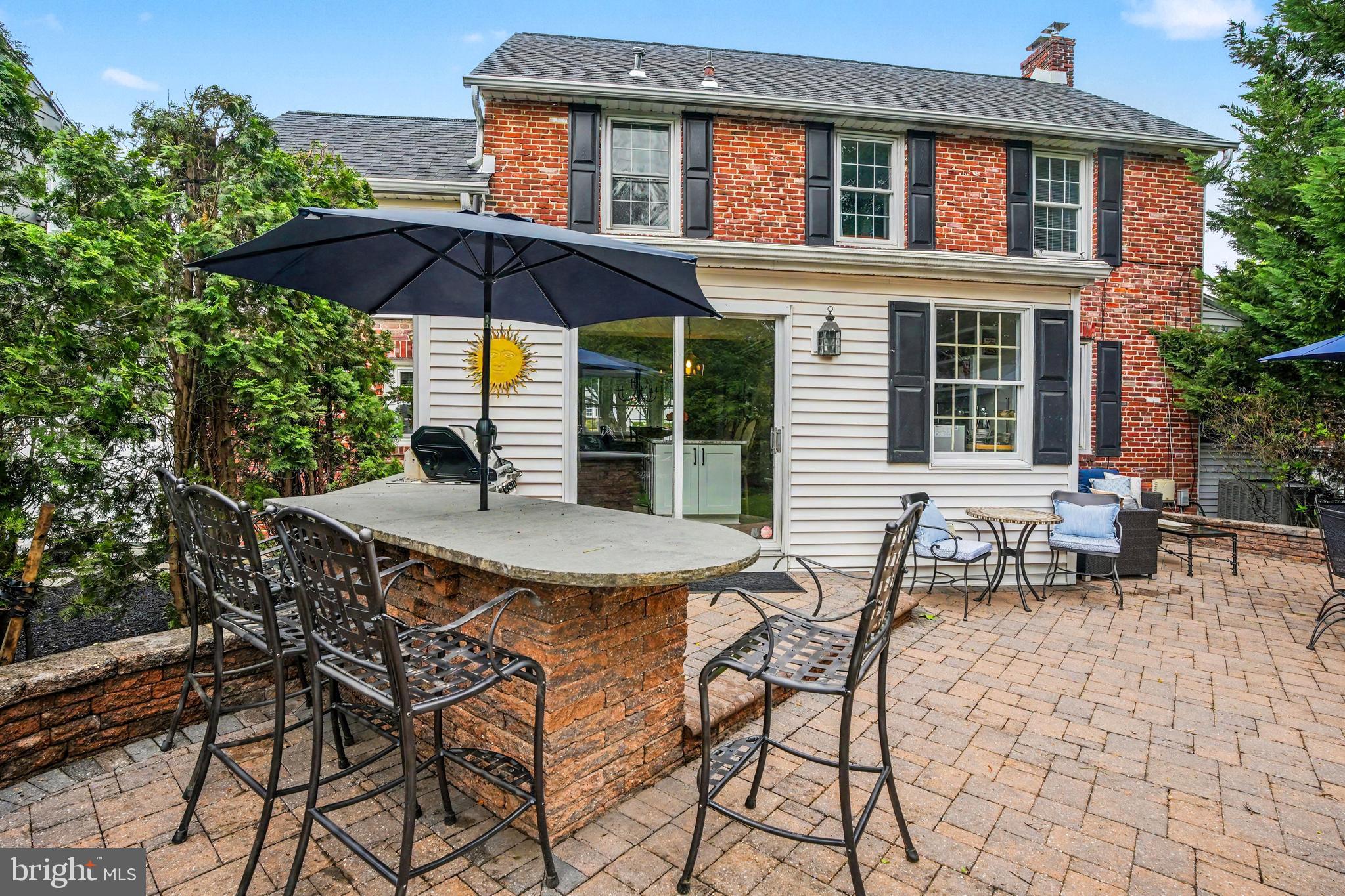 235 Hopkins Road Haddonfield, NJ 08033 - Photo 40 of 47 a view of patio with a table and chairs under an umbrella