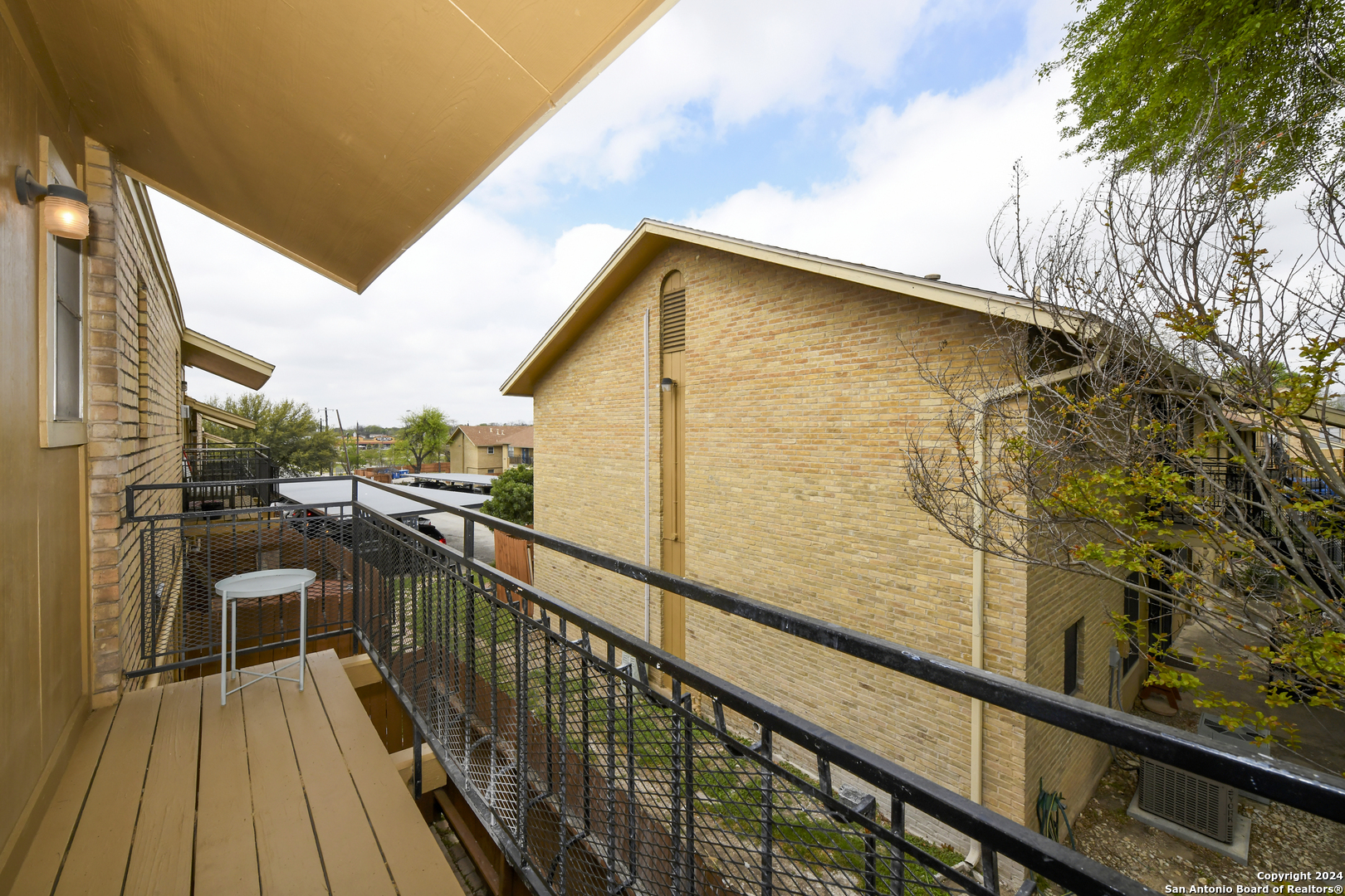 911 Vance Jackson Road, Unit 212 San Antonio, TX 78201 - Photo 24 of 30 a view of a balcony with wooden floor and fence