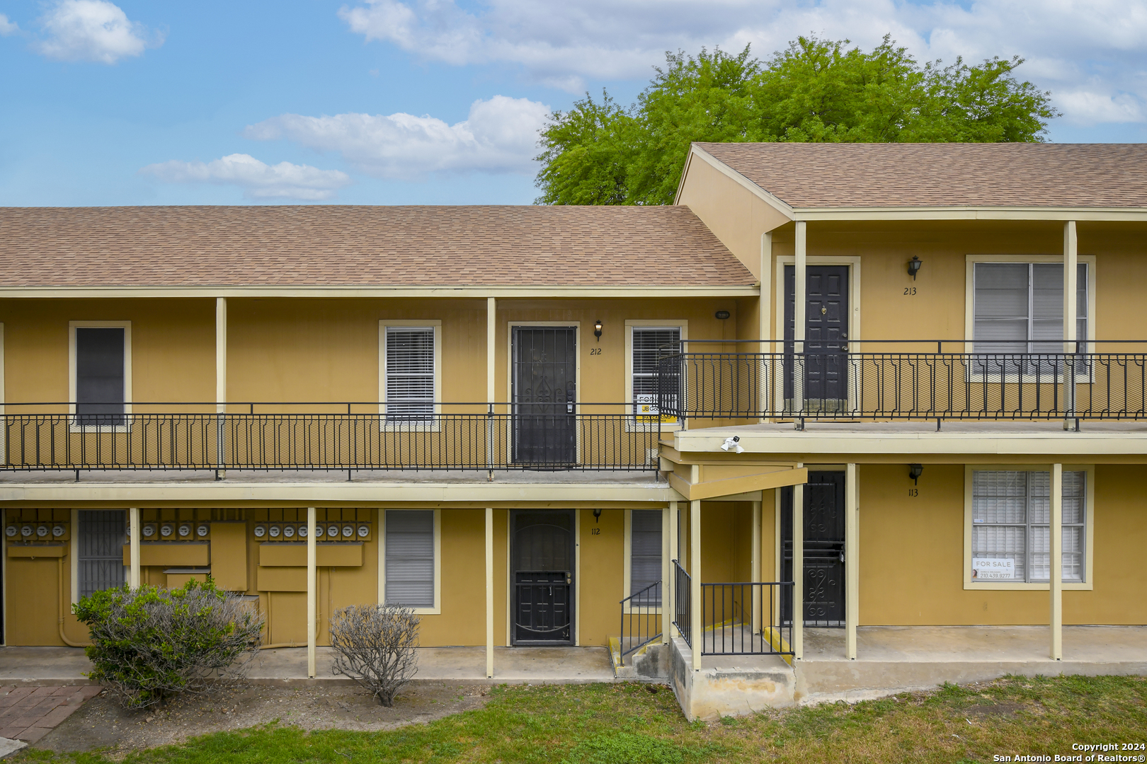 911 Vance Jackson Road, Unit 212 San Antonio, TX 78201 - Photo 25 of 30 a front view of a house with yard and green space