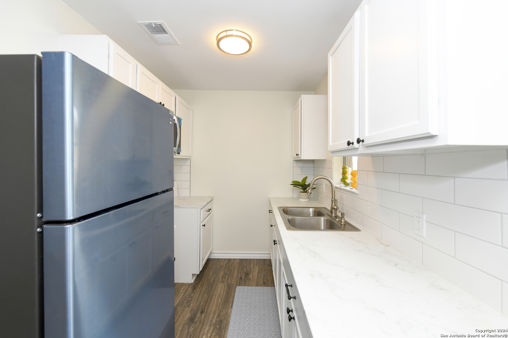 911 Vance Jackson Road, Unit 212 San Antonio, TX 78201 - Photo 9 of 30 a kitchen with a refrigerator and a sink
