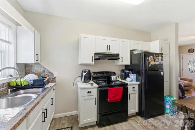 a kitchen with a dining table and chairs