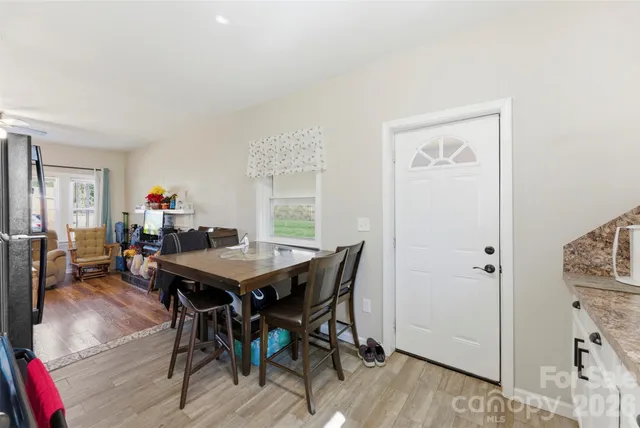 a bathroom with a granite countertop sink mirror vanity and toilet