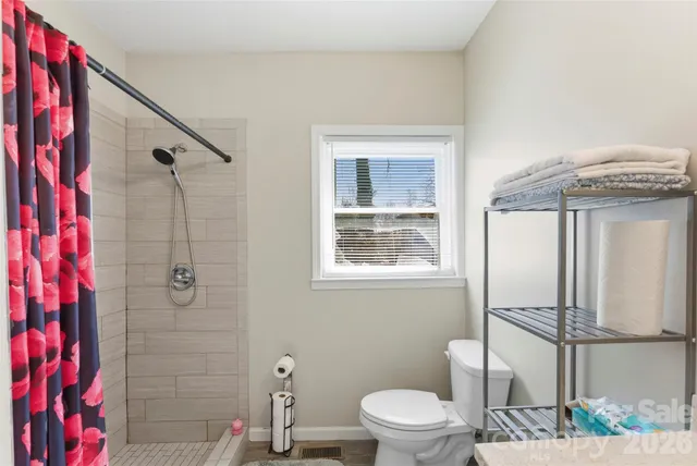 a bathroom with a shower and a shower curtain